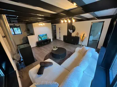 a large living room with a large white couch at Etwee Vakantiehuis in Lanaken
