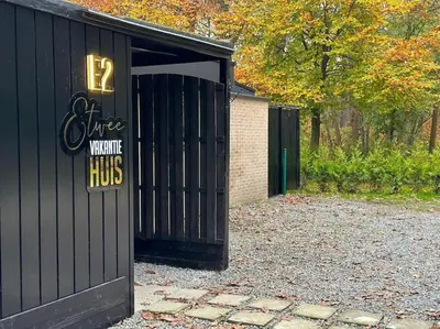 a black garage with a sign on it at Etwee Vakantiehuis in Lanaken