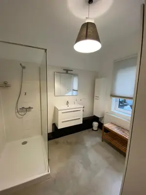a bathroom with a shower and a sink and a mirror at Loft St Remacle in Liège
