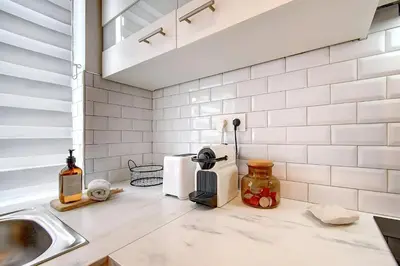 a kitchen with a sink and a counter top at - Le Cocoune - Cosy & Cute Flat in Liège