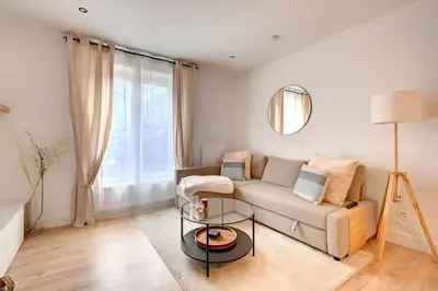 a living room with a couch and a table at - Le Cocoune - Cosy & Cute Flat in Liège