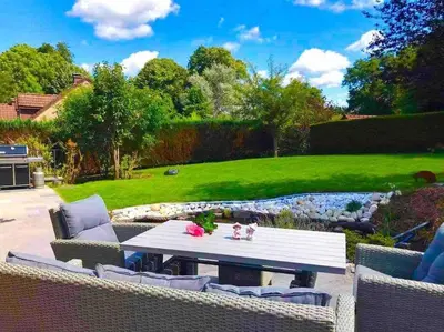 a patio with a table and chairs in a yard at Happiness at Vero in Verviers