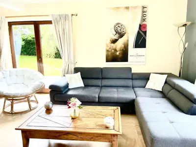 a living room with a blue couch and a coffee table at Happiness at Vero in Verviers
