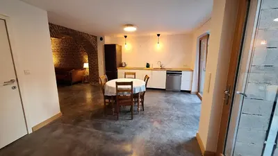 a kitchen and dining room with a table and chairs at Bed and breakfast Le fourchu fossé in Liège