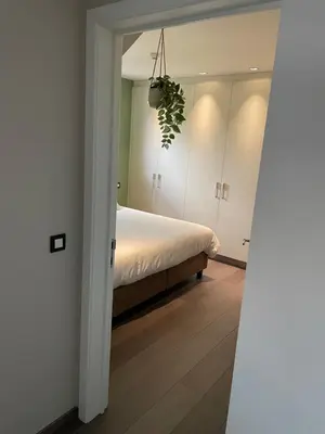a bedroom with a bed and a potted plant at Aurelia Glamping en B&B in Lommel