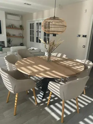 a dining room table with chairs and a pendant light at Aurelia Glamping en B&B in Lommel