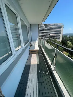 a balcony with a bench on top of a building at Appartement panoramique plein sud Liège in Liège