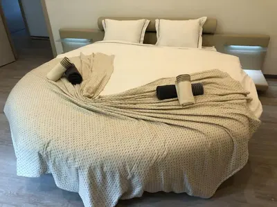 a bedroom with a white bed with a blanket on it at Riverside house in Trooz