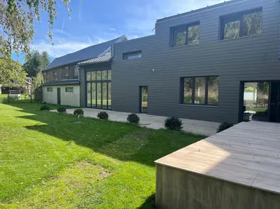 a large house with a large yard in front of it at Riverside house in Trooz