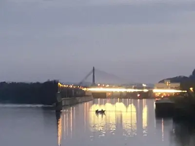 a bridge over a body of water at night at Waterside Zen - Maastricht in Visé