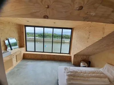 a room with a bed and a window in a house at Waterside Zen - Maastricht in Visé