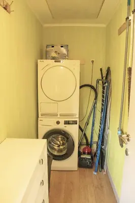 a laundry room with a washing machine and a washer at Hoeve Hofgaarde in Heers