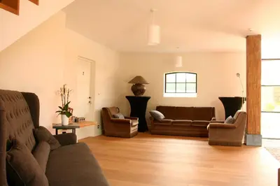 a living room with a couch and two chairs at O-Lit in Paal