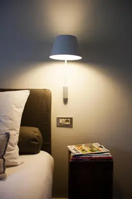 a lamp on a side table next to a bed at O-Lit in Paal