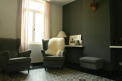 a living room with a chair and a window at O-Lit in Paal
