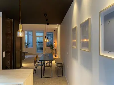 a dining room with a table and chairs in a room at 2 bedroom duplex in the historic heart of Liège in Liège