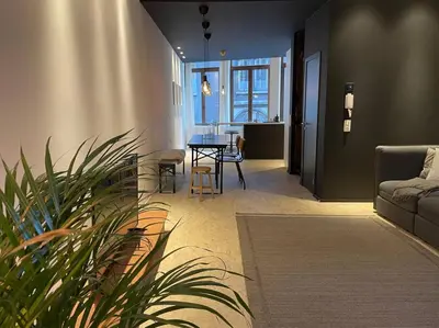 a living room with a table and a couch at 2 bedroom duplex in the historic heart of Liège in Liège