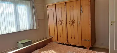 a room with a large wooden cabinet next to a window at A home away from home in Oudsbergen