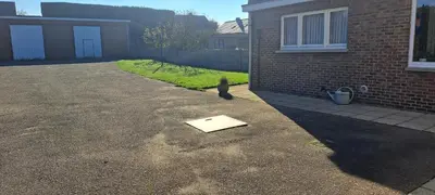 a book is laying on the ground in a driveway at A home away from home in Oudsbergen