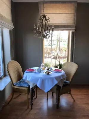 a dining room table with a blue table cloth and chairs at B&B Het Welthof in Bree