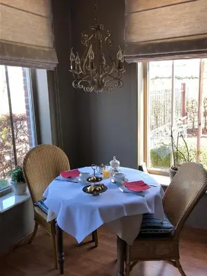 a dining room table with a blue table cloth on it at B&B Het Welthof in Bree