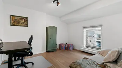 a living room with a desk and a couch at Maison Quatre-Vingt-Deux in Maasmechelen