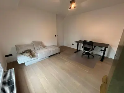 a living room with a couch and a table at Maison Quatre-Vingt-Deux in Maasmechelen