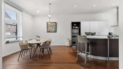 a kitchen and dining room with a table and chairs at Maison Quatre-Vingt-Deux in Maasmechelen