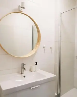 a white bathroom with a sink and a mirror at 1 bedroom apartment in Liège center - 2nd floor in Liège
