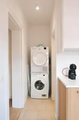 a washer and dryer in a small room with at 1 bedroom apartment in Liège center - 2nd floor in Liège