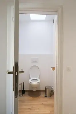 a bathroom with a white toilet in a room at 1 bedroom apartment in Liège center - 2nd floor in Liège