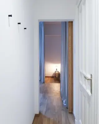 an empty room with a hallway with blue curtains at 1 bedroom apartment in Liège center - 2nd floor in Liège