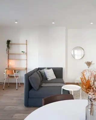 a living room with a blue couch and a table at 1 bedroom apartment in Liège center - 2nd floor in Liège