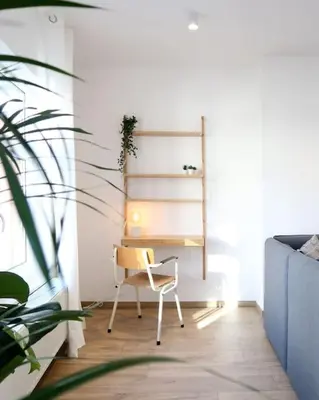 a desk in a room with a chair and a plant at 1 bedroom apartment in Liège center - 2nd floor in Liège