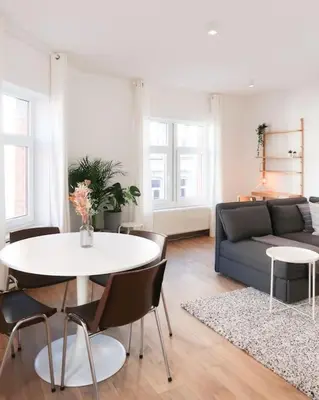 a living room with a table and a couch at 1 bedroom apartment in Liège center - 2nd floor in Liège
