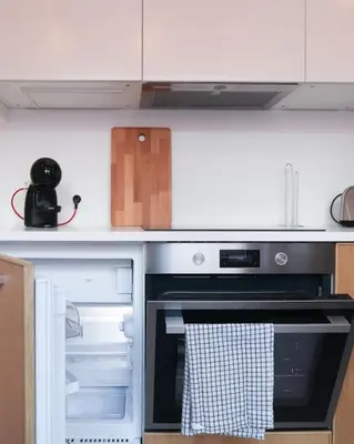 a kitchen with an oven with its door open at 1 bedroom apartment in Liège center - 3rd floor in Liège