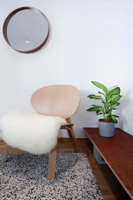 a white chair sitting next to a table with a plant at 1 bedroom apartment in Liège center - 3rd floor in Liège