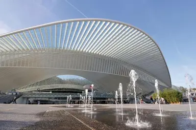a building with water fountains in front of it at Angleur Appartement 001 rez arrière in Liège