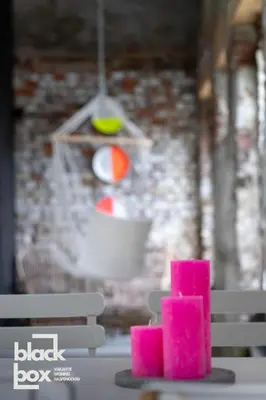 a stack of pink candles sitting on a table at Black Box by De Schrijfbar - vakantiewoning Haspengouw in Wellen