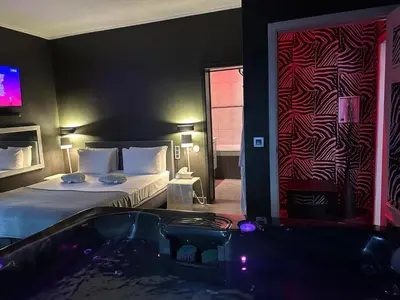 a hotel room with a bed and a tub at lelysblanc in Liège