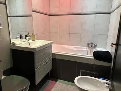 a bathroom with a sink and a tub and a toilet at lelysblanc in Liège