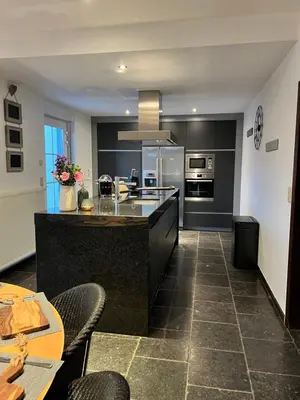a large kitchen with a large island in the middle at De Boomgaard Voeren in Voeren