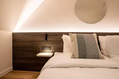 a bedroom with a large bed with a wooden headboard at Boutique Hotel Annamaes, Maastricht-Hoge Kempen in Lanaken