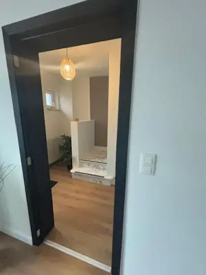 a hallway with a door open to a room with at La Redoute in Tongeren