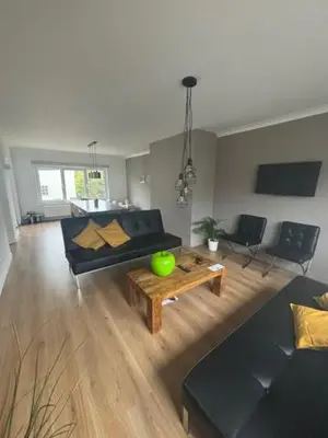 a living room with a couch and a table at La Redoute in Tongeren