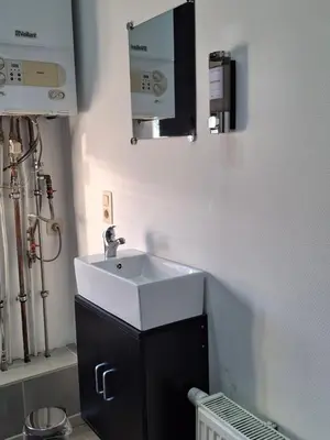 a bathroom with a white sink and a mirror at La Vie en Rose in Verviers