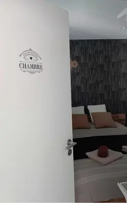 a door leading into a bedroom with two beds at Sweet Dreams in Visé