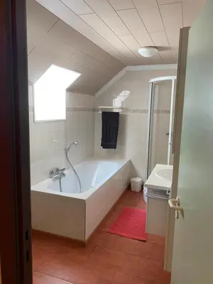 a bathroom with a bath tub and a sink at Hengelhoef Ceder 106 in Houthalen-Helchteren