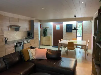 a living room with a couch and a table in a kitchen at Hengelhoef Ceder 106 in Houthalen-Helchteren