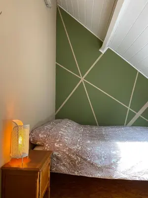 a bedroom with two beds and a green wall at Hengelhoef Ceder 106 in Houthalen-Helchteren